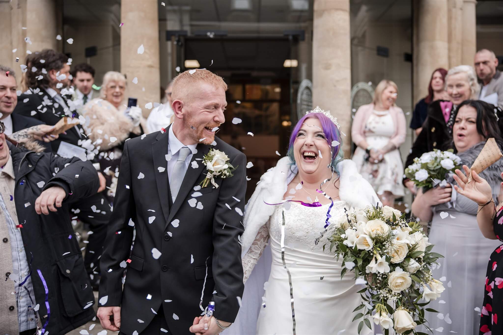 Bonnie and Andy walking through confetti outside Salisbury Methodist Church during their wedding in Salisbury.