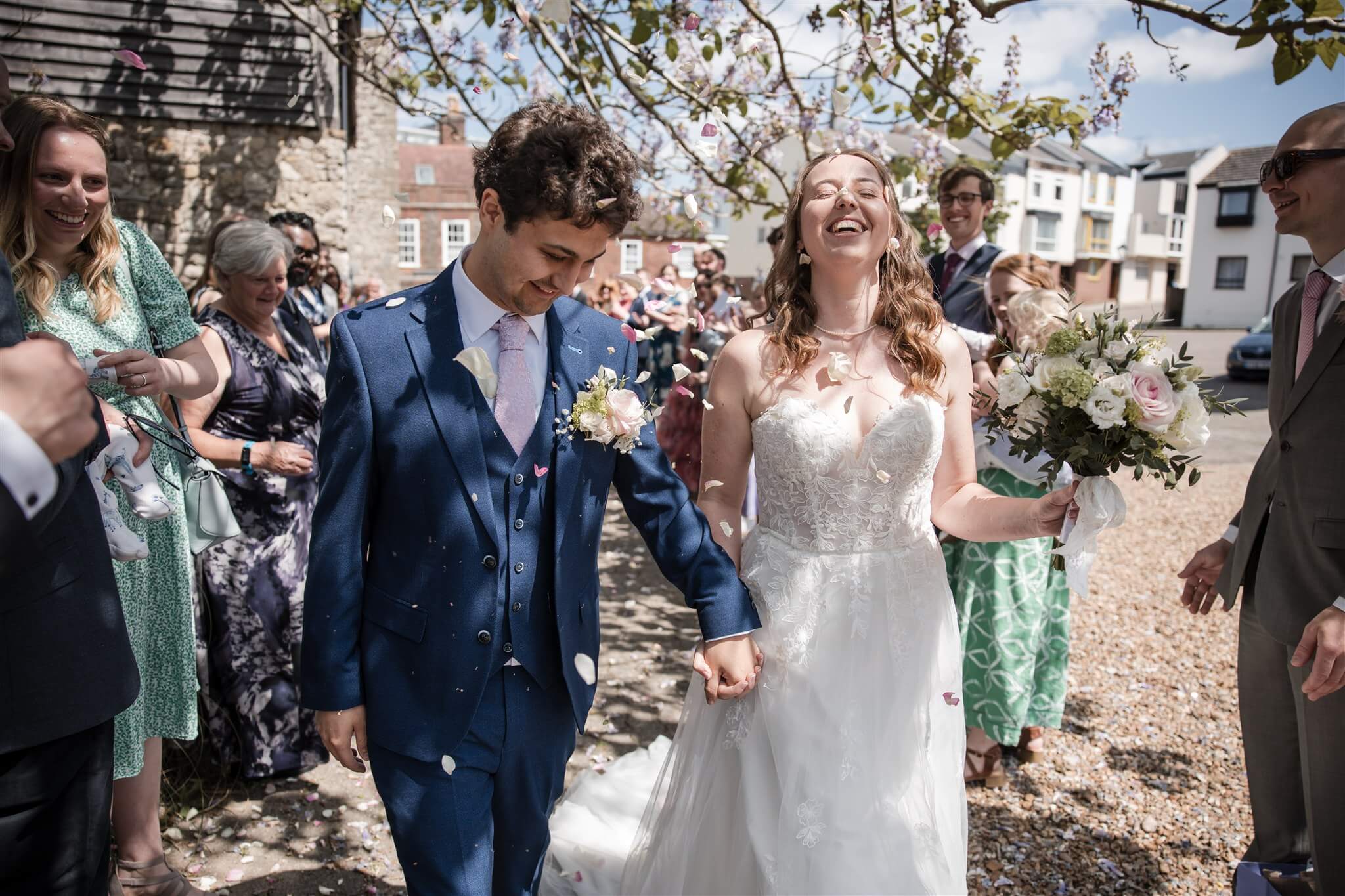 Clare and Josh walking through confetti after their ceremony at Westgate Hall in Southampton