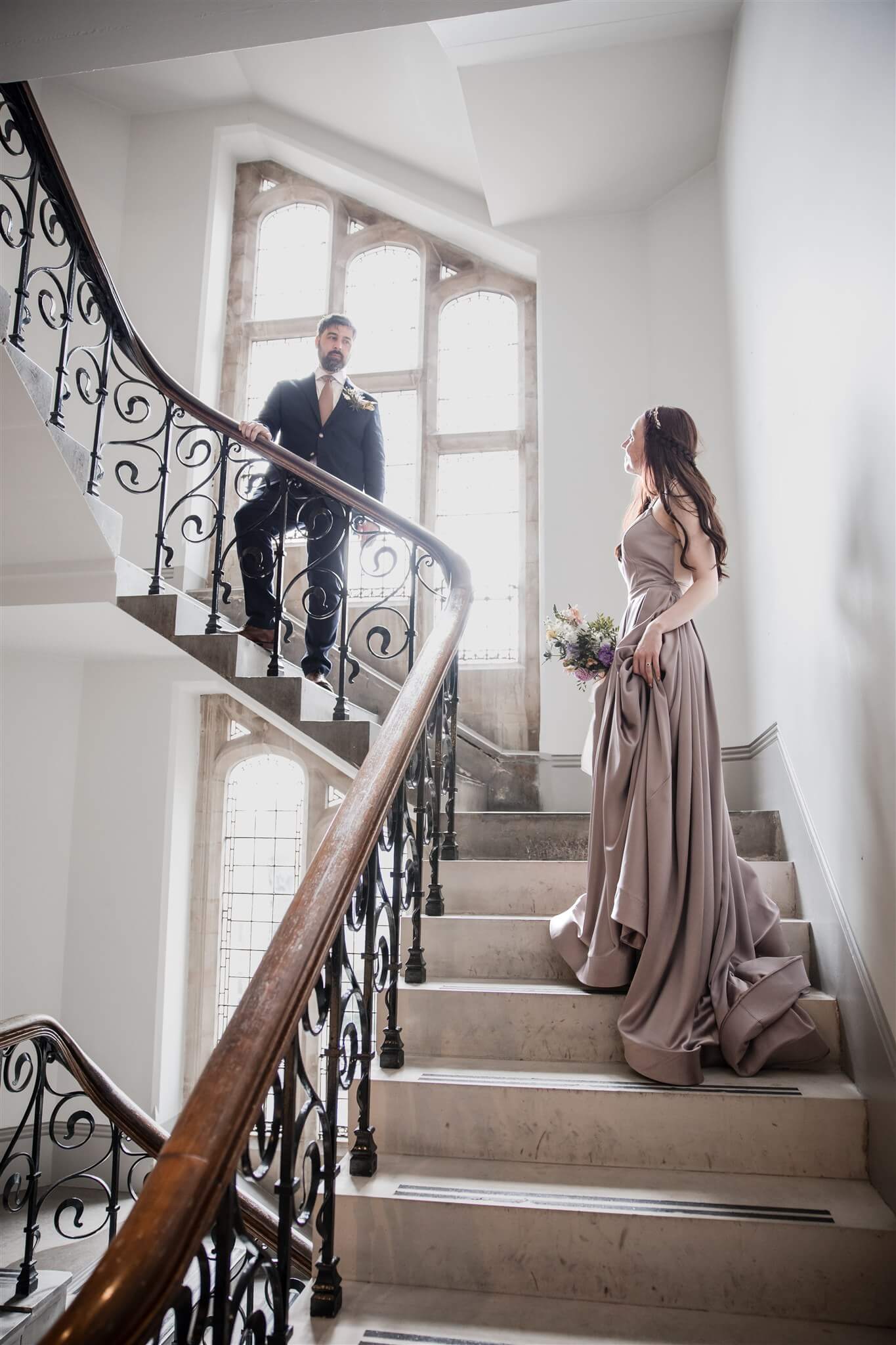 Anna and Alex on the staircase at Winchester Registry Office during their wedding in Winchester.