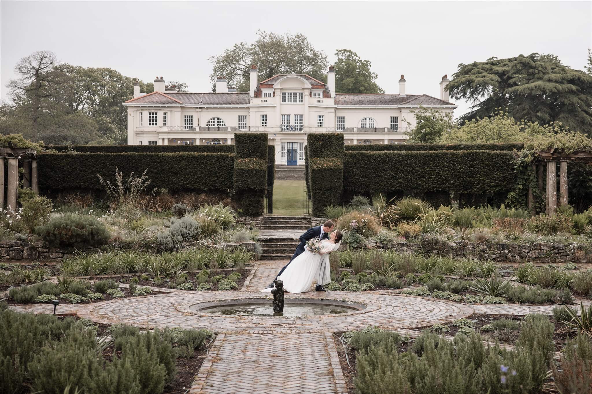 Sarah and Hermanus in the gardens of Townhill Park House during their Southampton wedding.